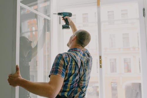 handyman fixing windows