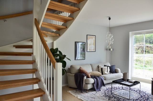 couch in living room with staircase