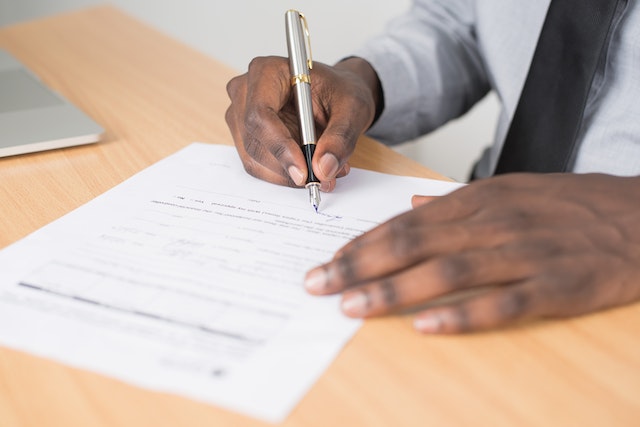 man signing a contract