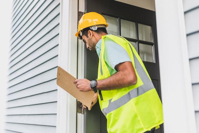 person inspecting a house