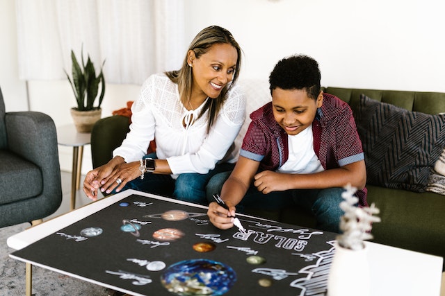 mother and son working on a science fair project 