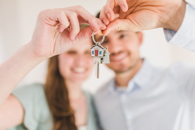 two people holding up house keys